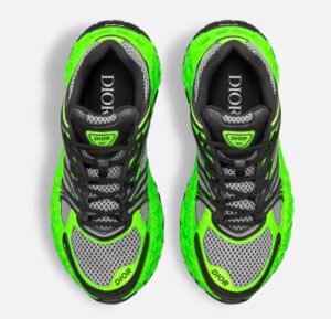 B35 NXXT limited edition shoe in neon green, black technical fabric, and gray mesh displayed on minimalist concrete backdrop
